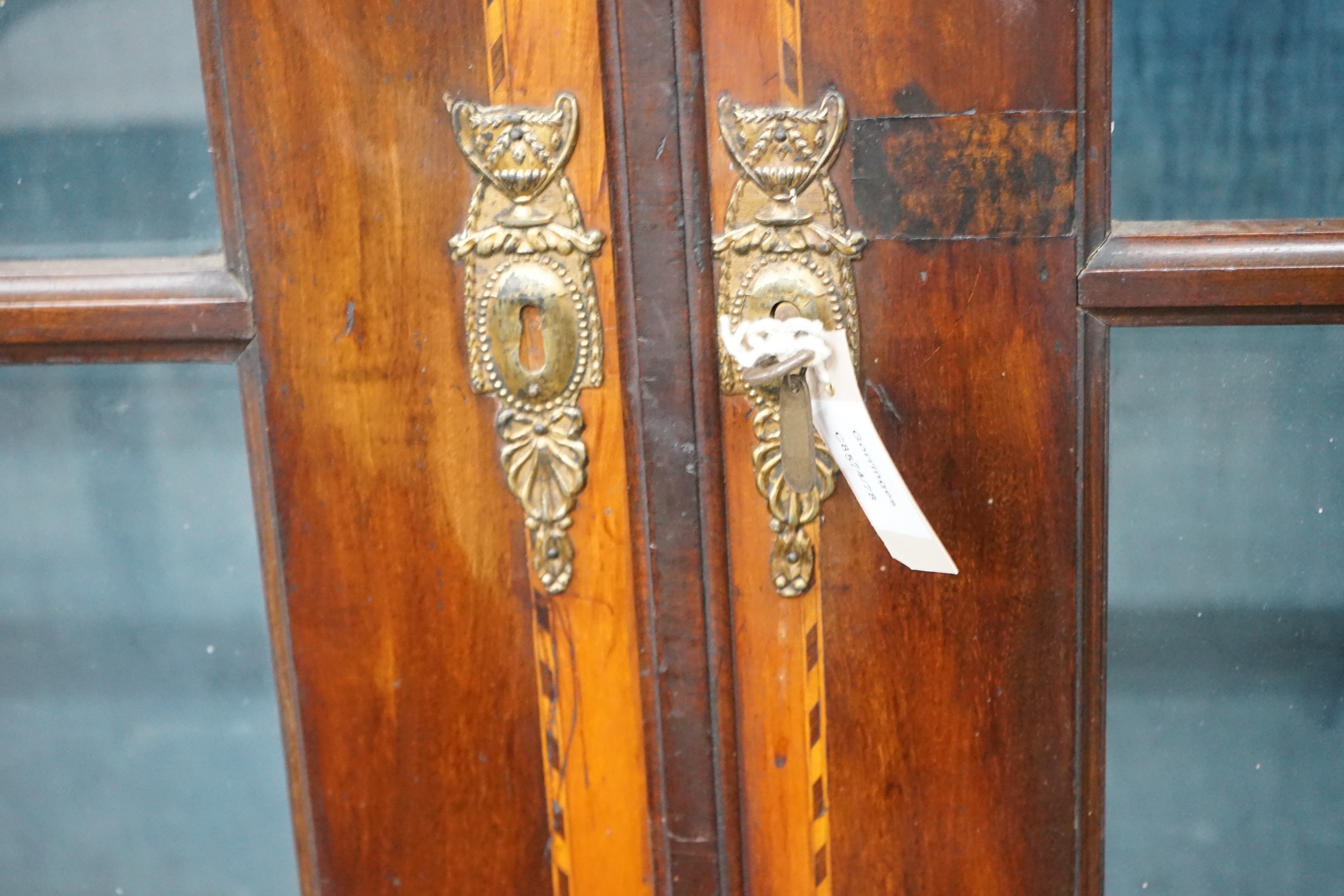 An 18th century Dutch walnut and fruitwood vitrine, with two glazed doors, width 148cm, depth 35cm, height 202cm